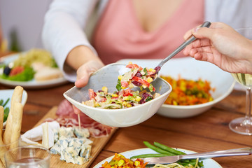 Wall Mural - people eating salad at table with food