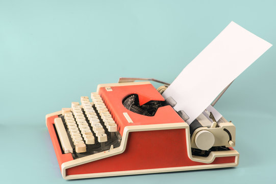 Red typewriter on a blue background