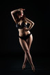 © staras - Beautiful sexy woman in lingerie posing on black studio background, low key studio shot