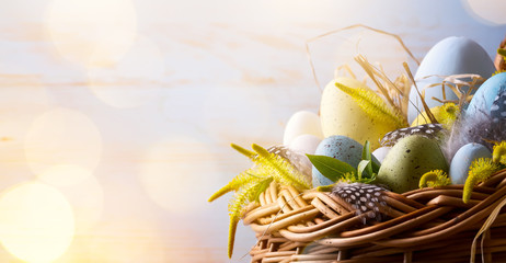 Wall Mural - Easter background with Easter eggs in the basket