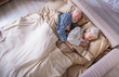 © Yakobchuk Olena - Sweet dreams. Top view of calm elderly husband and wife lying in bedroom. Their eyes are closed. Pensioners are relaxing in bed and hugging