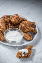 Wall Mural - chicken wings with ranch dressing on white plate in bright setting