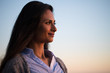 © blvdone - Young Indian woman looking up sunset sky