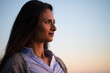 © blvdone - Young Indian woman looking up sunset sky