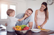 © ivanko80 - Portrait of a family preparing lunch in the kitchen.