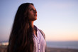 © blvdone - Young Indian woman looking up sunset sky