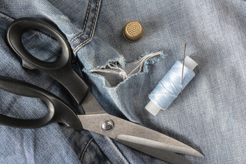 Jeans pants with hole for sewing knives and threads