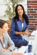 © ASDF - Two confident businessman using a computer, working at a table