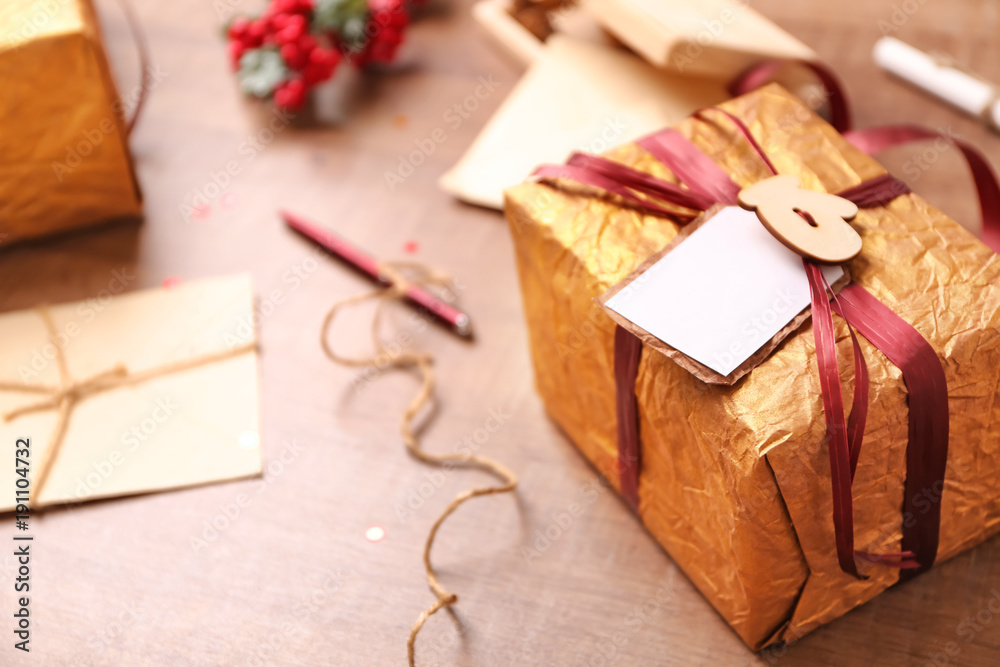 Beautifully decorated gift box on wooden table