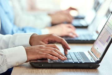 Black man's hands typing on laptop. Brown male hands pressing buttons on laptop computers.