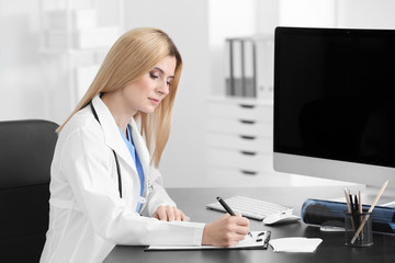 Poster - Female doctor filling up application form in consultation room