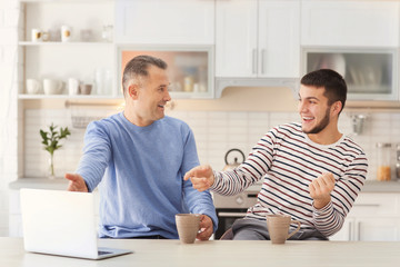 Wall Mural - Mature man spending time with his son at home