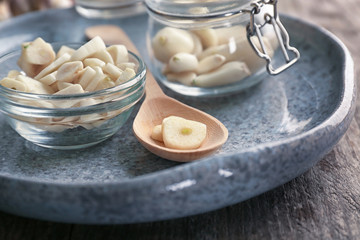 Poster - Bowl and spoon with chopped garlic on plate