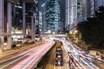 Poster - Traffic rushing in Hong Kong island while a tram car wait.