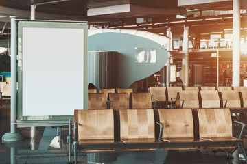 Wall Mural - Informational empty banner template partly covered by empty seat rows of Airport terminal waiting hall; clean white mockup of advertising billboard in shopping mall or railway station depot