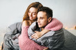 © stakhov - Happy cute girl in love at home embracing boyfriend. Soft focus on the husband. Artwork
