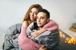 © stakhov - Young couple hugging at home and looking in camera. Artwork. Soft focus on the husbend