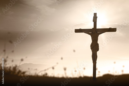 Poster Good friday concept: Silhouette Jesus Christ and cross over meadow sunset