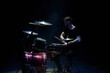 © nagaets - music, people, musical instruments and entertainment concept - male musician with drumsticks playing drums on the stage.