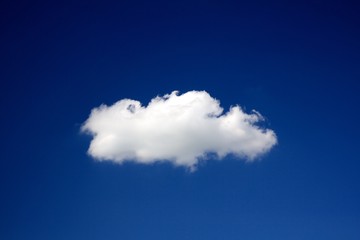 Lonely cloud on a clear deep blue sky