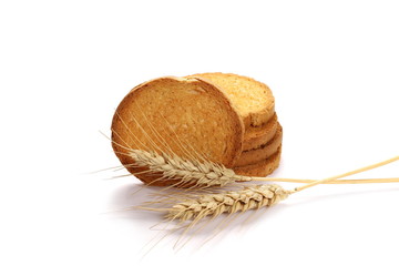 Wall Mural - Integral wholewheat rusks, bread slices and ears of wheat isolated on white background