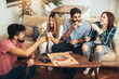 © Mediteraneo - Group of young friends eating pizza.Home party.Fast food concept.
