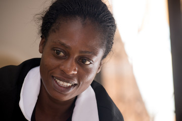 Wall Mural - Portrait of a emotional beautiful cheerful African girl in work clothes