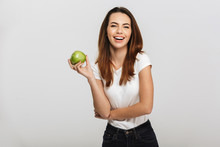 Portrait Of A Happy Young Woman Holding Green Apple
