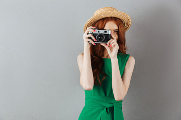 Sticker - Redhead young lady photographer holding camera.