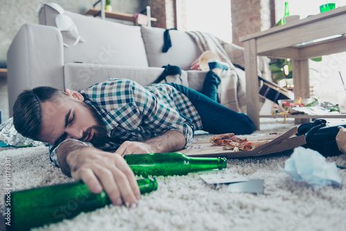 Fotografía Sick drunk dreamy bearded guy clothed in checkered shirt and denim jeans is slee