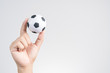 © bonnontawat - Hand holding small soccer ball or football