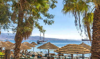 Sunny day at central beach and marina in Eilat - famous resort and recreation city in Israel. 