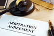 Arbitration agreement resolution of commercial disputes on a desk.