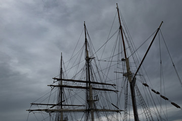 Wall Mural - Sailboat Mast  and ropes with cloudy blue sky in the background