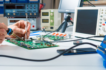 Canvas Print - To repair the PCB of a modern monitor at the service center. Laboratory electronic processor technology