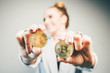 close-up golden coin, fashioned woman holding bitcoin have fun and smile.