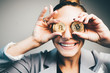 close-up portrait fashioned woman in gray business suit have fun with two bitcoin coins.