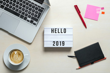 Wall Mural - Hello 2019 written on lightbox in office as flatlay