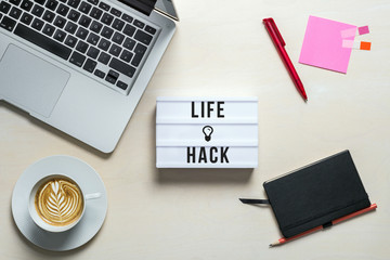 Wall Mural - Life hack written on lightbox in office as flatlay