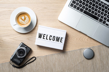 Wall Mural - Welcome written on lightbox in office as flatlay