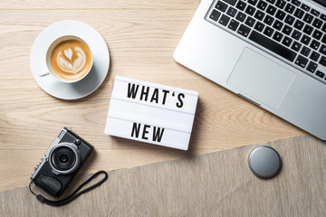 Wall Mural - What's new written on lightbox in office as flatlay