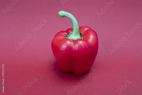 Fotografia, Obraz Fresh, healthy and juicy red bell pepper with a phallic green stork isolated aga