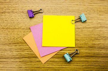 Paper sticker note on wooden background. Blank forms for workers notes.