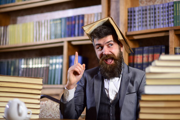 Leinwandbilder - Teacher with beard with opened book on his head