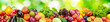 canvas print picture - Panorama of fresh vegetables and fruits on blurred background of green leaves.