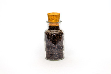 Coffee beans in a glass jar with a cork on white background
