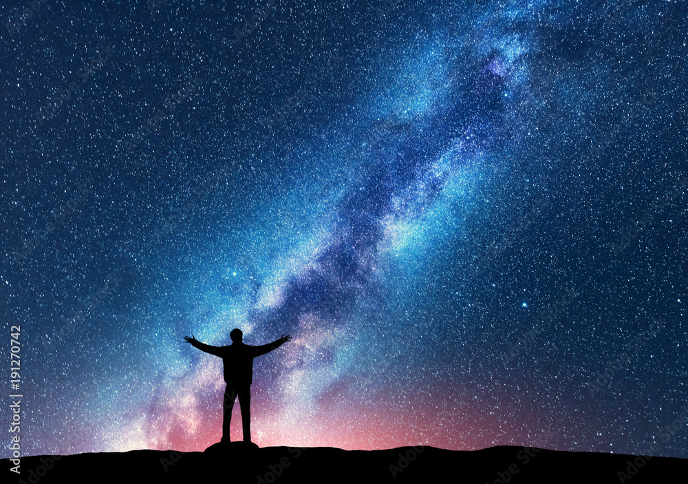 Space. Milky Way with silhouette of a standing happy man with raised up ...