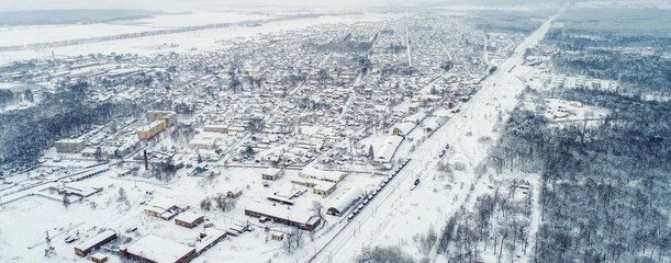 Wall Mural - Aerial winter top down view high above rural slow living by small village