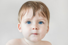 Portrait Of A Blonde Baby Boy With Blue Eyes