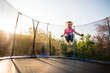 © Martinan - Fearless little kid jumping high on trampoline